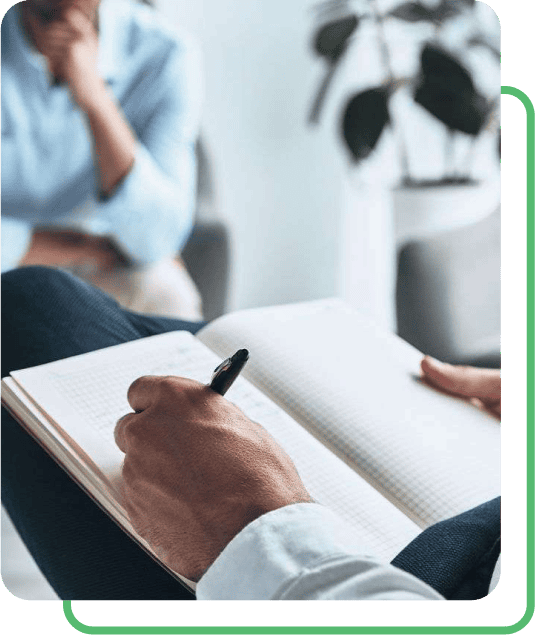 therapist writing in a book